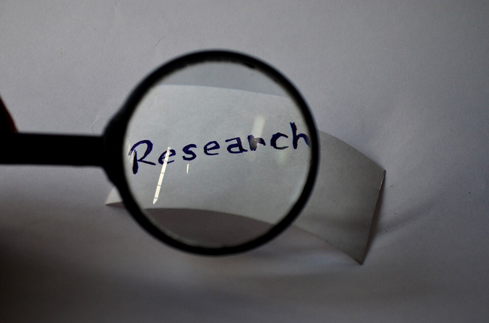 Magnifying glass over the word research